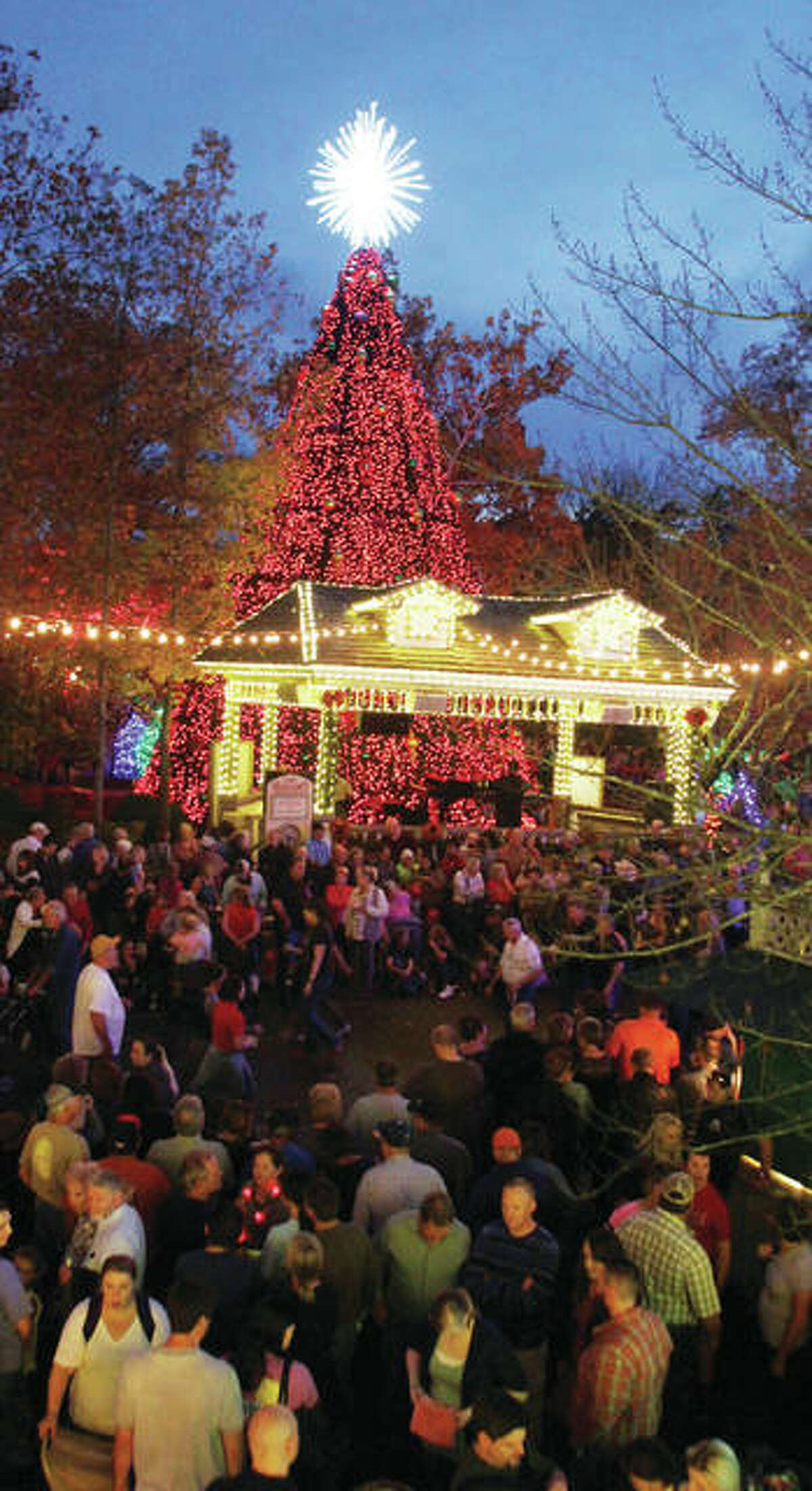 People watch the lighting of the five-story Christmas tree at Silver Dollar City in Branson, Missouri. The Christmas season runs now through Saturday, Dec. 30, at the theme park, and is part of the larger “Ozark Mountain Christmas” in Branson.