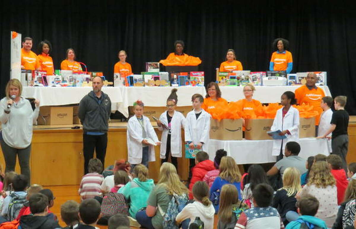 Amazon employees show Woodlawn Elementary students the $10,000 of STEM equipment the company donated to the school.