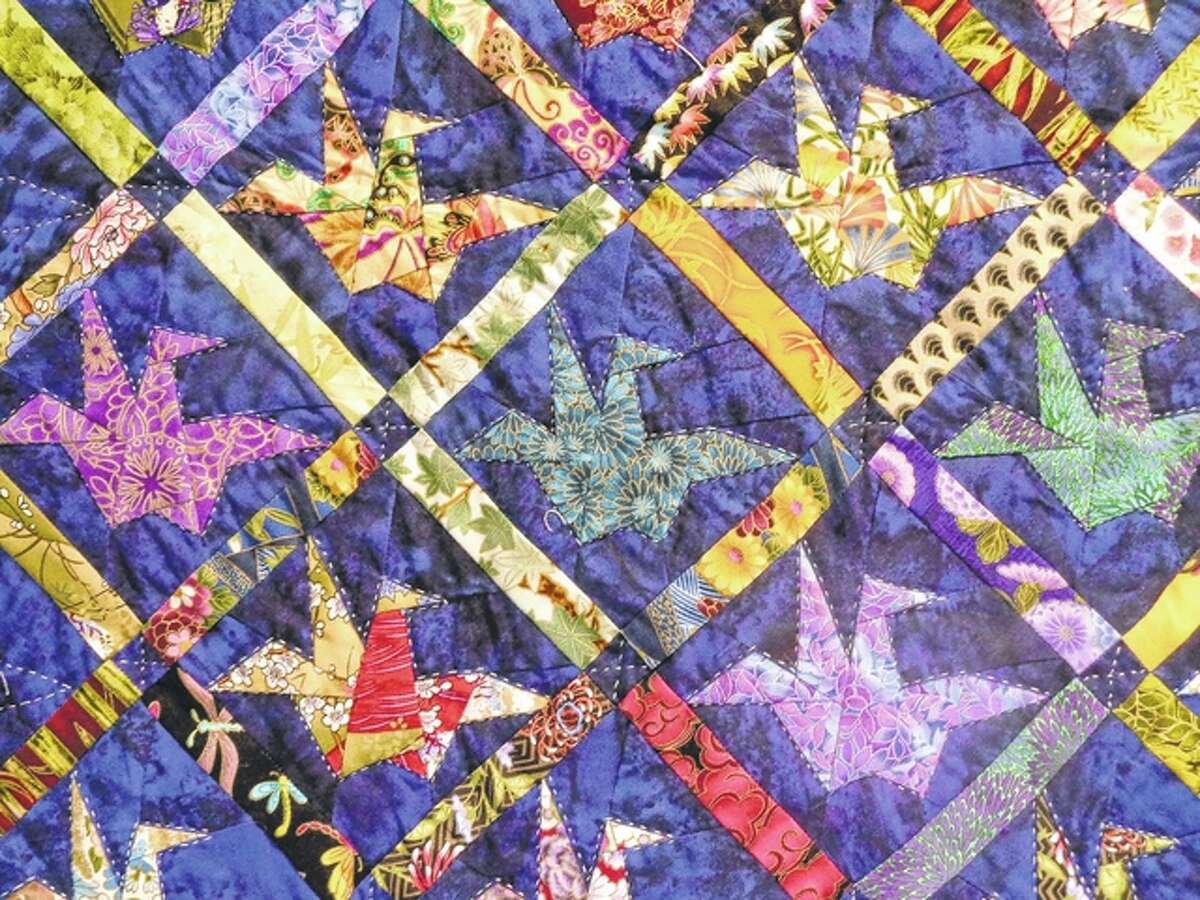 The colorful patterns of a quilt by Laverne Roy fill a display at the Jacksonville Public Library.