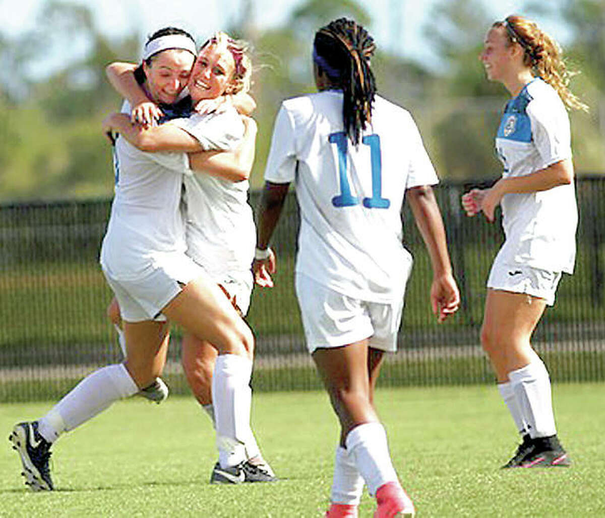 Megan McDonald, left, hugs teammate Kassidy Louvall after Louvall scored a first-half goal Friday at the NJCAA National Tournament. Also pictured are LC’s Senate Letsie (11) and Aivia Dubois.