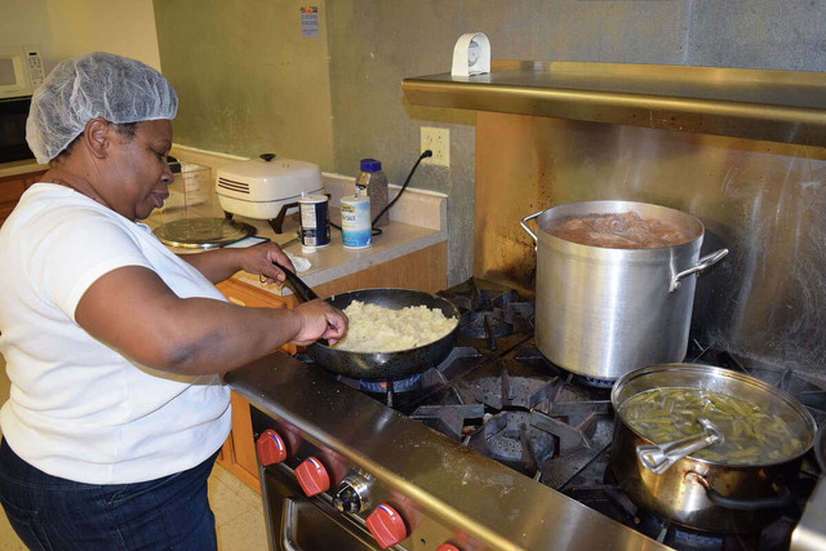 Spirit of Faith Soup Kitchen director Polly Pulley prepares potatoes, green beans and ham.