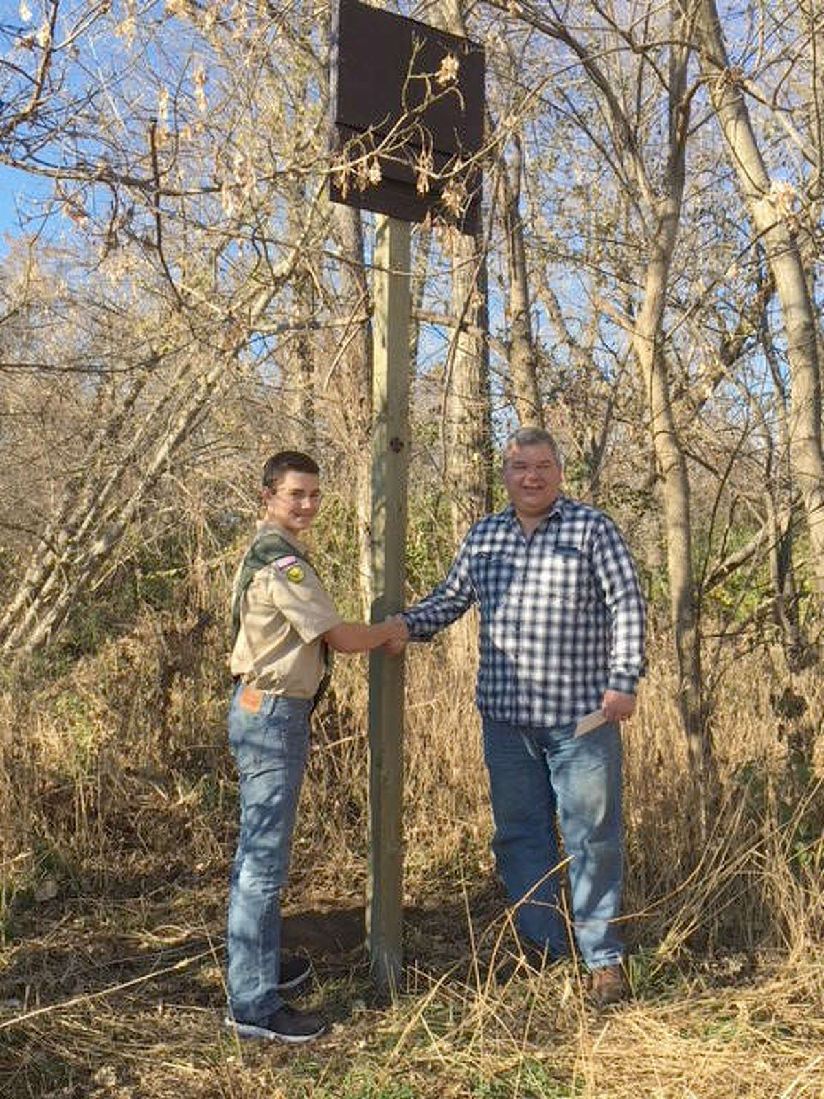 Bethalto Mayor Alan Winslow shakes the hand of local Boy Scout Ethan Scott, who recently installed three new bat houses at the Bethalto Sports Complex as part of his Eagle Scout project.