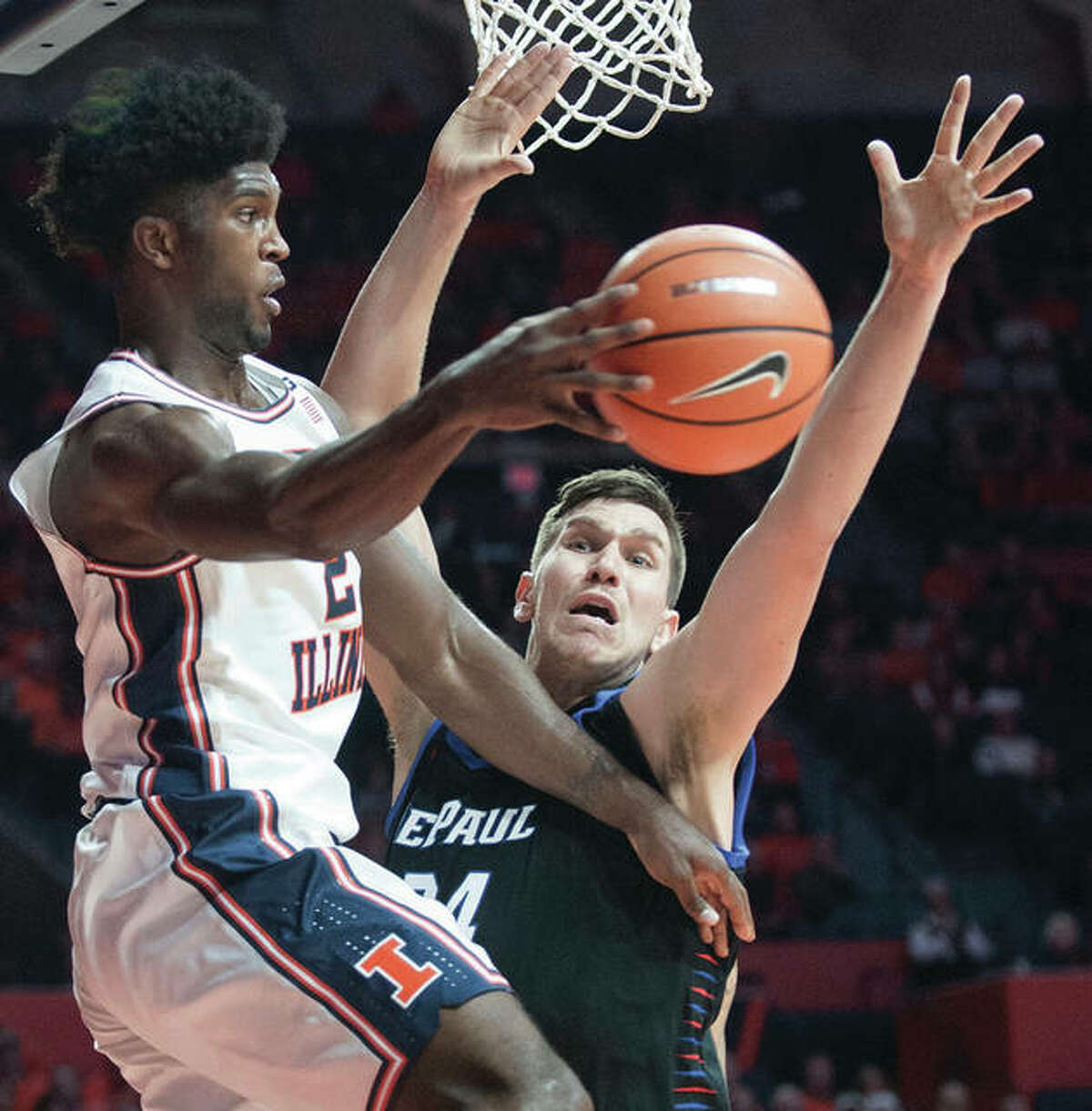 Illinois’s Kipper Nichols (left), who passing around DePaul’s Marin Maric in Champaign, had his first career double-double Sunday in Champaign.