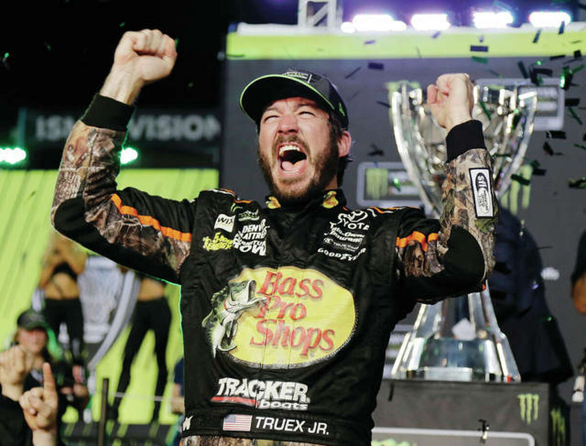Martin Truex Jr. celebrates in Victory Lane on Sunday after winning the NASCAR Cup Series race and season championship at Homestead-Miami Speedway in Homestead, Fla.