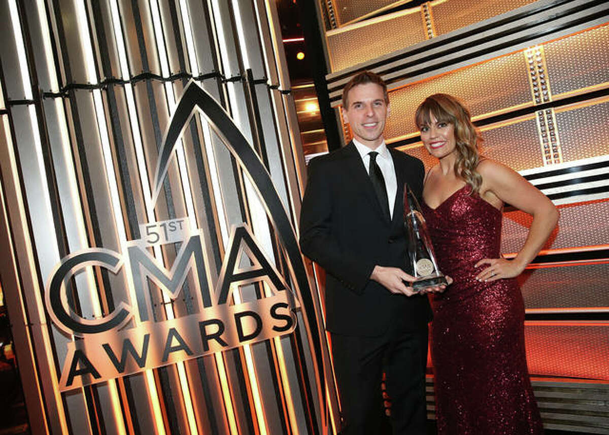 Jesse Tack and Amanda Valentine accept the Large Market Personality of the Year award at the Country Music Association Awards in Nashville.