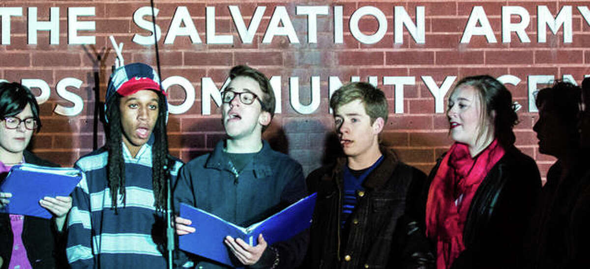 Singers from Marquette High School perform Tuesday evening in front of the Alton Salvation Army during the Alton Corps’ Tree Of Lights ceremony. Students from the school’s drama club presented this year’s Tree of Lights Chairs, Mark and Mary Cousley, with a check of more than $300 raised during a recent performance for the Red Kettle Campaign. The Cousleys announced this year’s goal for the Alton-area campaign at $90,000. Last year, the campaign brought in $100,000, beating its $85,000 goal.