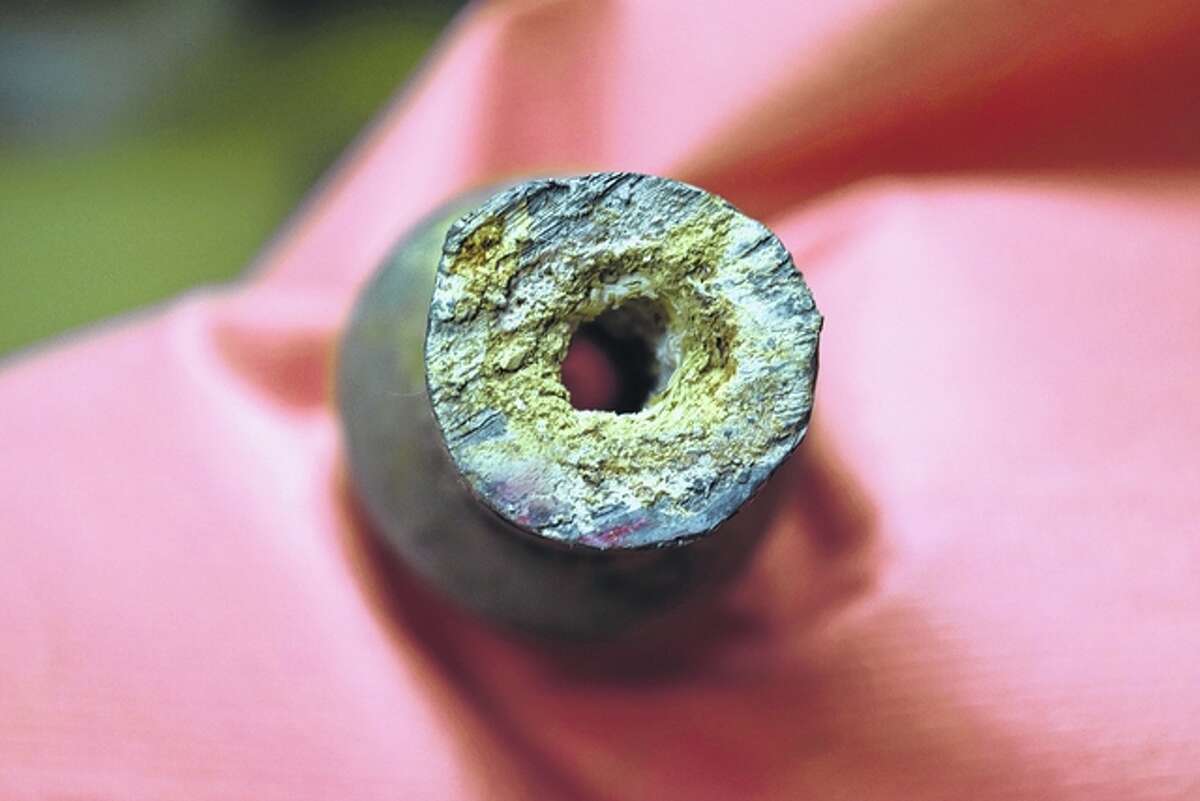 The inside of this old lead pipe shows a buildup of calcium carbonate, a chemical used to prevent corrosion that can cause lead to leach into water.