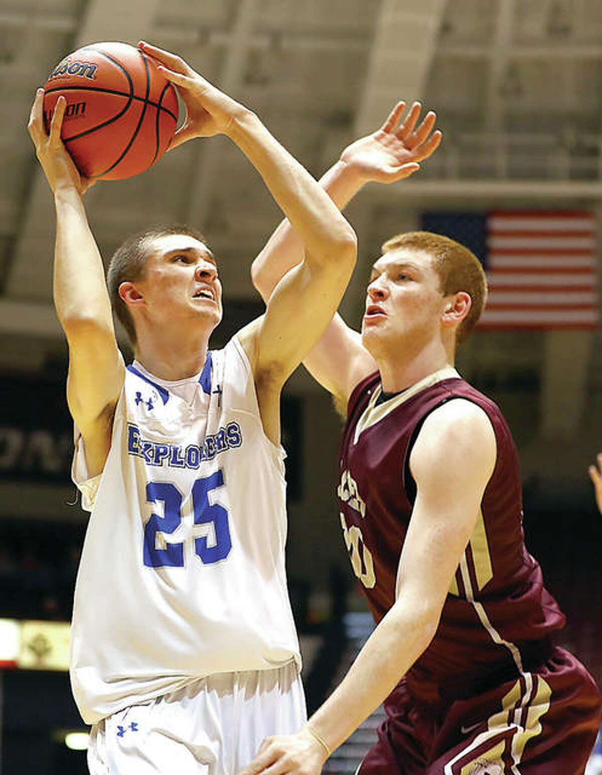 Marquette Catholic’s Jake Hall (25), shown looking to shoot over Mount Carmel’s Justin Carpenter last season in the Carbondale Class 2A Super-Sectional at SIU Arena, was named MVP of the Metro East Lutheran Thanksgiving Turkey Tip-Off Classic on Saturday night in Edwardsville. Marquette beat host MEL in the championship game.