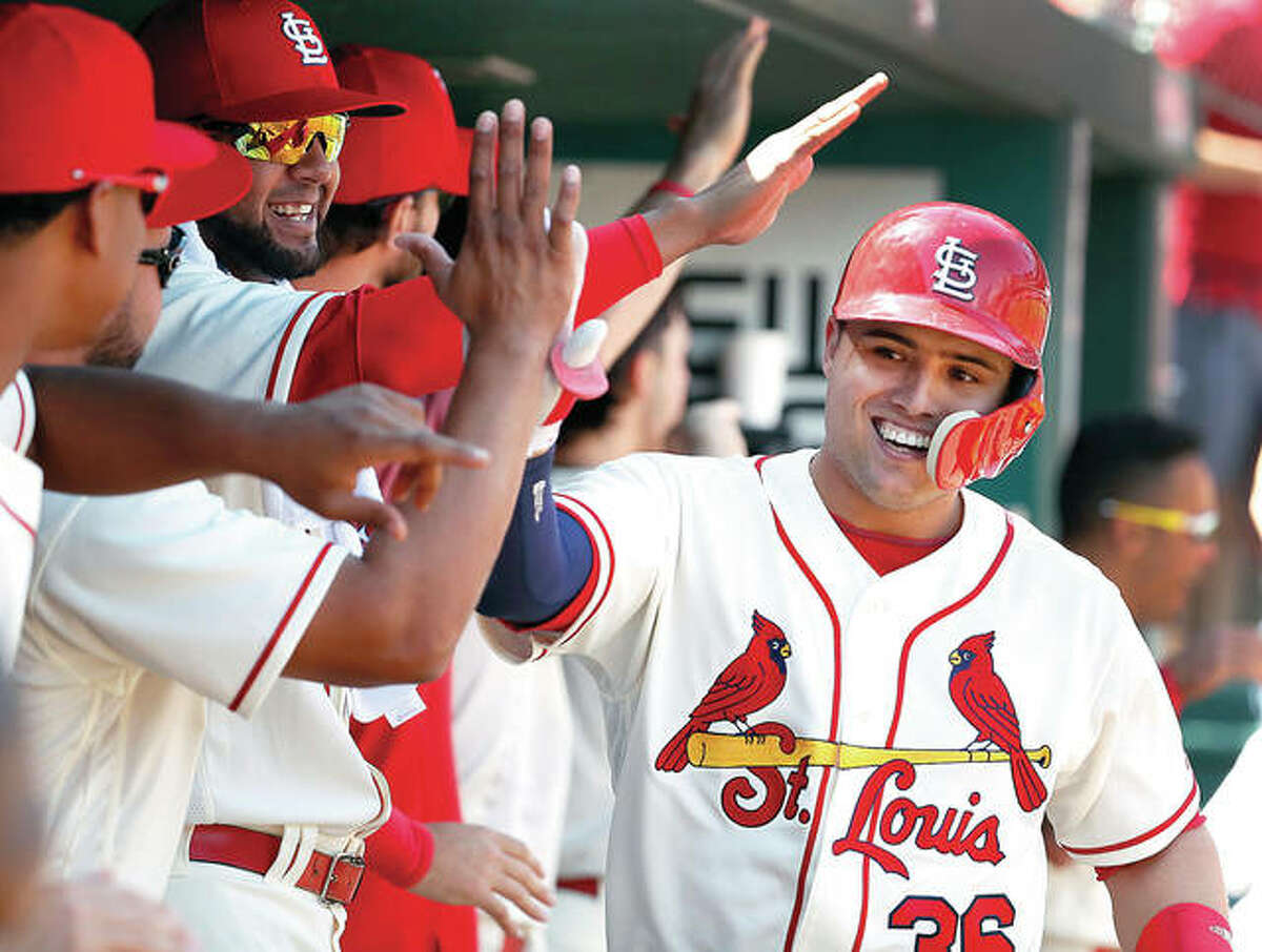 Aledmys Diaz is congratulated by Cardinals teammates after hitting a three-run home run last April against Cincinnati. Diaz was traded to Toronto Friday for minor league outfielder J.B. Woodman.