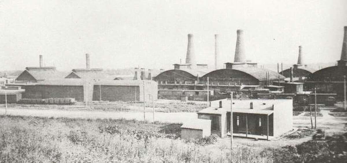 An indication that the move from a small factory at Tenth and Bell streets was the wise move for Illinois Glass is visible in this photograph taken early in this century. The many bottle-shaped smokestacks for the huge furnaces indicate that business flourished and expansion was a necessity.