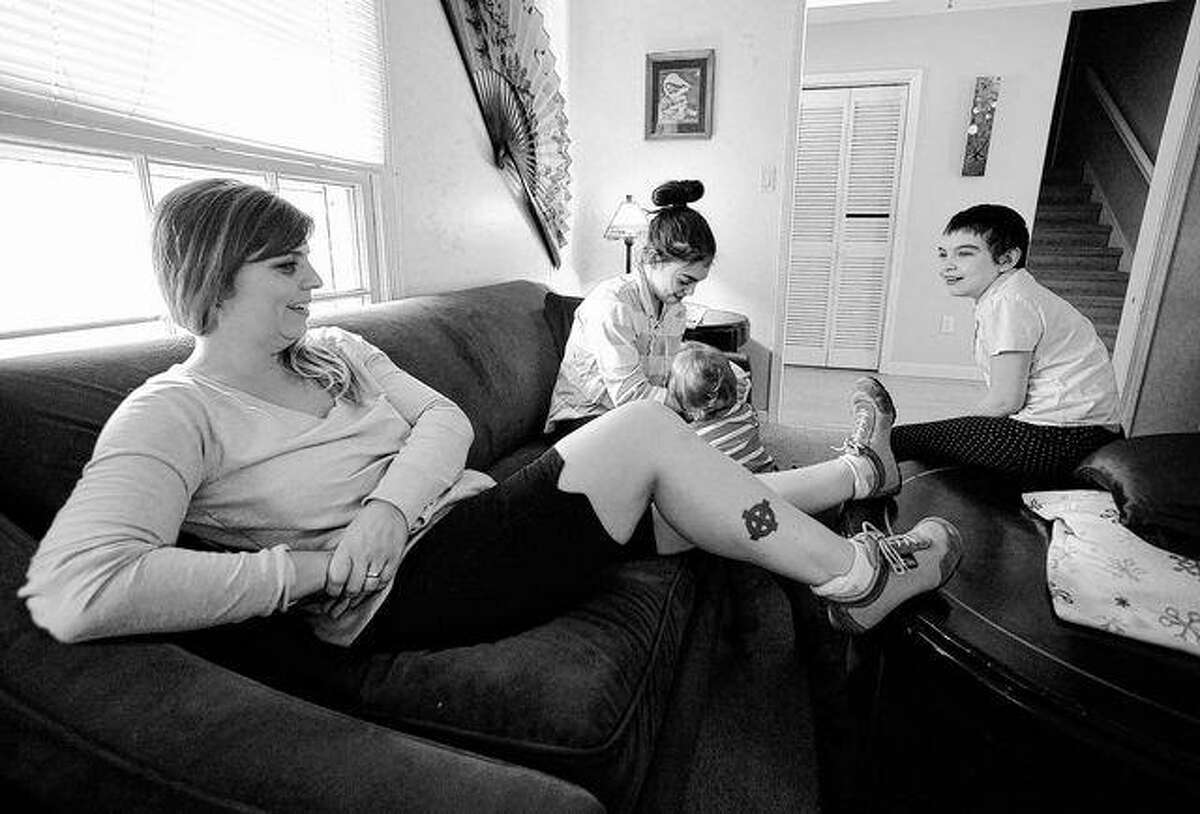 In this Wednesday, Jan. 11, former skinhead Shannon Martinez, left, talks with some of her children in their home in Athens, Ga. A member of the racist group starting in her teen years, Martinez quit decades ago and is now worried about a possible rise in extremism in the United States. AP Photo | Jay Reeves