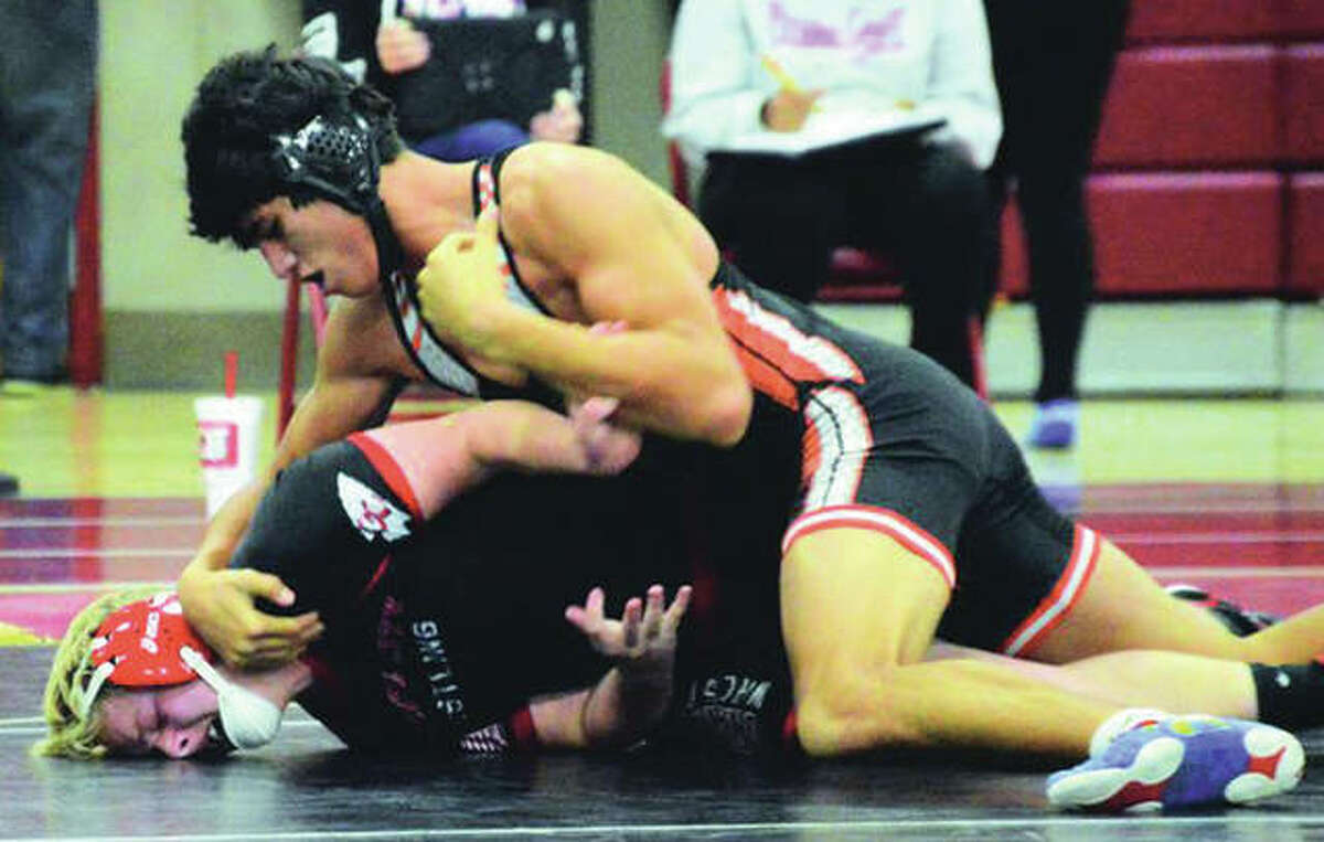 Edwardsville’s Eric Epenesa (top) works over Granite City’s Brendan Davis during a 170-pound bout Thursday in Granite City. Epenesa won a 5-4 decision.