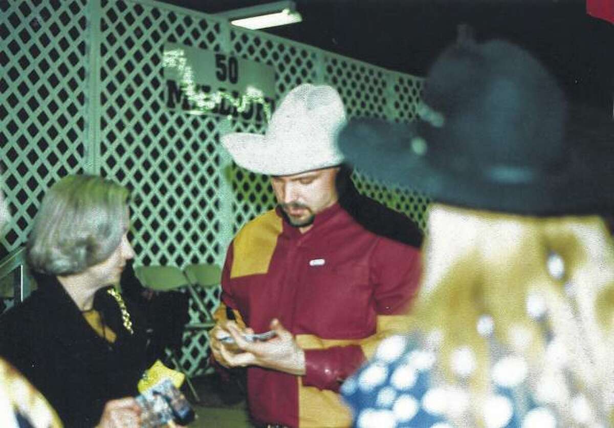 Garth Brooks signs an autograph for a fan March 10, 1995, while visiting the Capitol-EMI Manufacturing plant in Jacksonville.