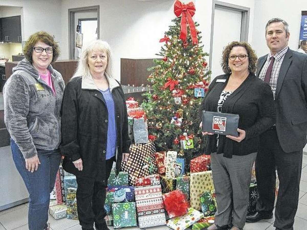 From left, Jenny Vogel and Nancy Rivera of Big Brothers Big Sisters of Southwestern Illinois with First Bank’s Carrie Mackey and Doug Brantley.