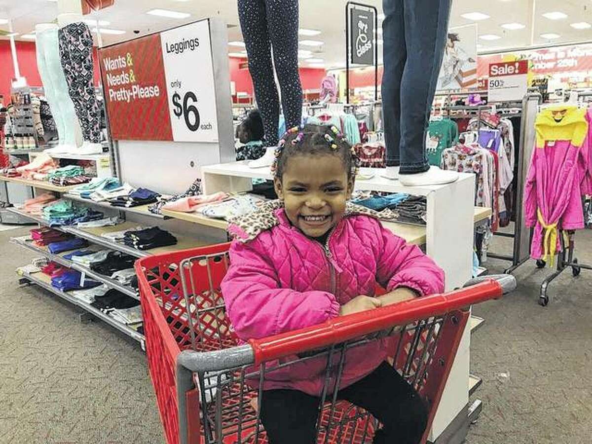 Chyna Dandridge, 4, smiles at the idea of getting new toys and leggings for herself. Her and her family were among those chosen for the 19th annual NAACP shopping spree at the Alton Target.