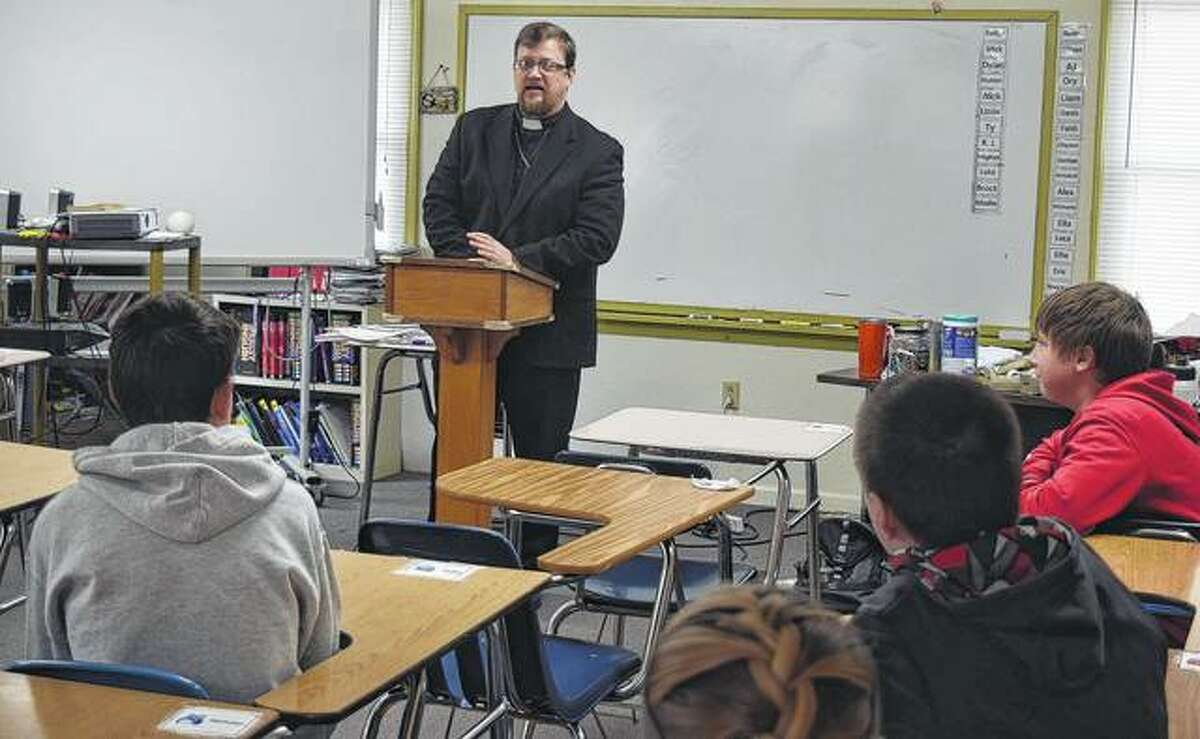 Pastor William Orr speaks to a group of students from Salem Lutheran School on Thursday.