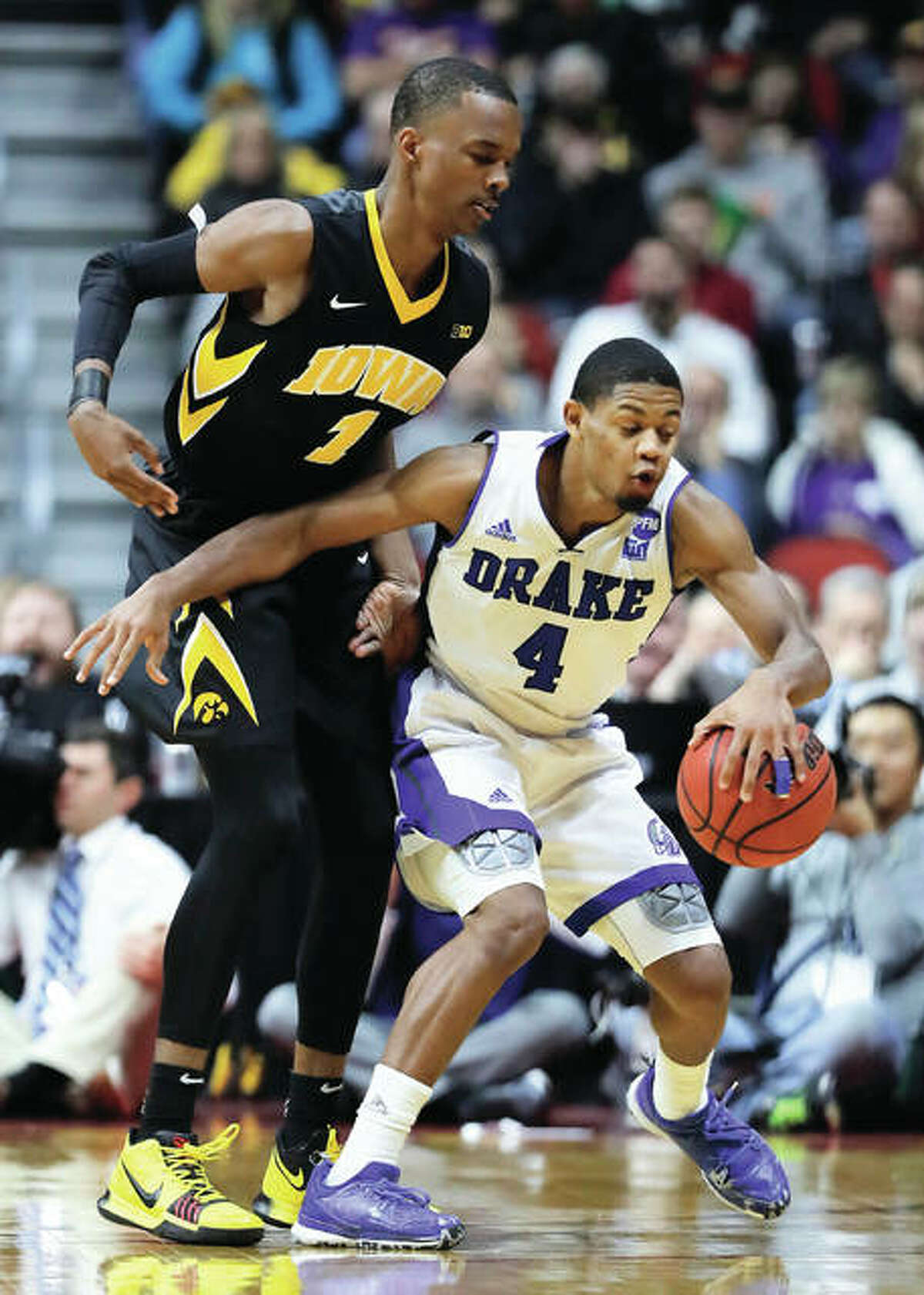 Drake guard De’Antae McMurray (4), a senior from Alton, drives around Iowa’s Maishe Dailey during a NCAA college basketball game Dec. 16 in Des Moines, Iowa. Iowa won 90-64. On Friday night back in Des Moines, the 6-foot-2 McMurray scored 16 points in the Bulldogs’ 81-57 victory over Maryland Eastern Shore that snapped Drake’s three-game losing streak. McMurray is second on the team in scoring at 12.0 points per game. The former prep standout at both Marquette Catholic and Alton high schools is shooting 40 percent from 3-point range and has scored in double figures in each of Drake’s last four games. The 6-7 Bulldogs open Missouri Valley Conference play at home on Thursday against Bradley.