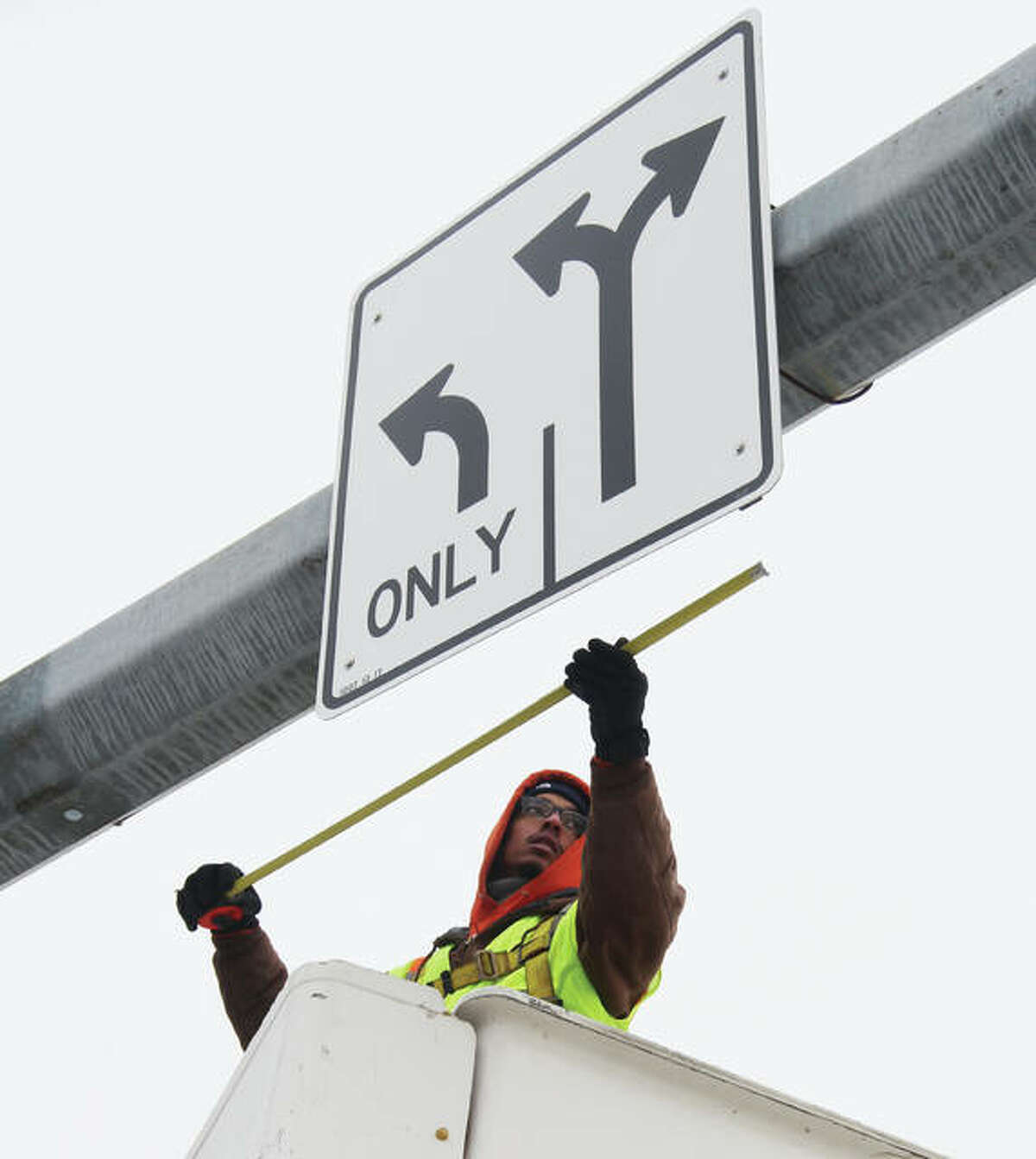 Chris Morgan, an employee of Wegman Electric Inc. of Bethalto, measures before installing conduit on a monotube sign truss on the Clark Bridge on Thursday morning. The conduit will hold wires that will provide electricity to a license plate recognition camera system that Wegman workers will install Friday. The cameras are set to begin operating this weekend, alerting police to any vehicle that is reported stolen or if the owner has a felony warrant. The cameras, by recording license plates of passing cars and trucks, also will assist police in identifying owner of a vehicle used in a crime. Alton, Godfrey and Madison County State’s Attorney’s Office are sharing cost of the cameras.