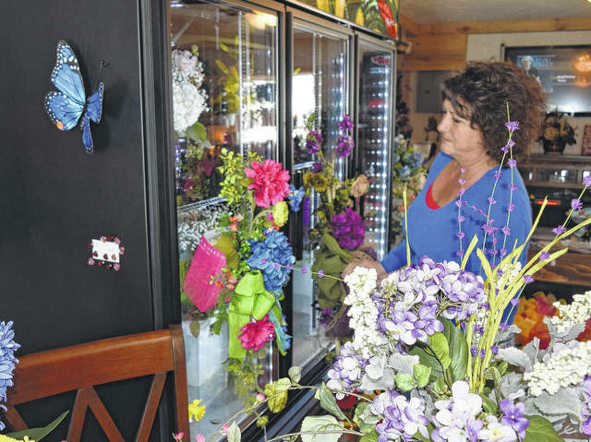 Penny Nagel Fricke looks at some of the flowers in her new floral and garden shop, Penny’s Garden Party in Waverly.