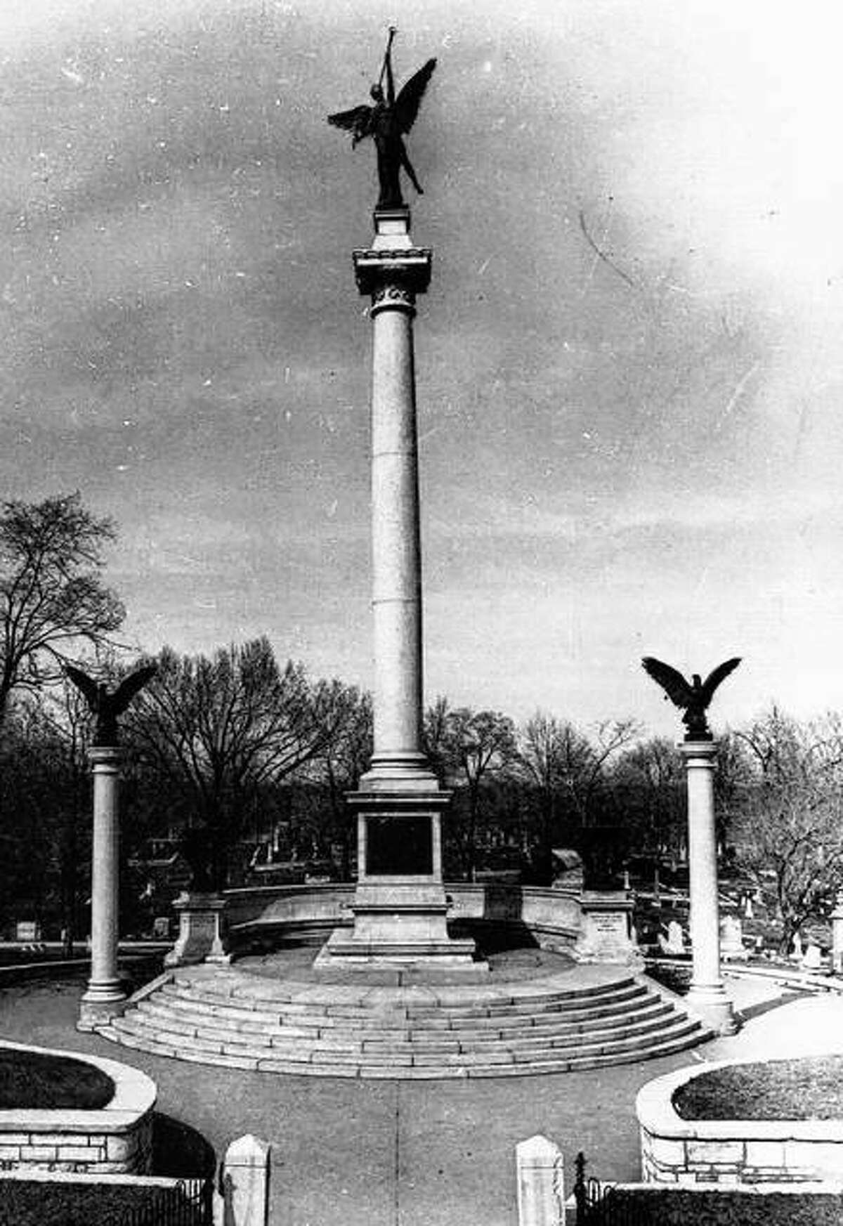 The Lovejoy Monument soars high over the hills and streets of Alton. Located in Alton City Cemetery, the monument consists of a massive column of Barre granite 93 feet in height. The column is surmounted by a seventeen foot high bronze statue depicting Victory. The base of the column is surrounded by a terrace, granite steps and walkways. Bronze plates on the memorial commemorate Lovejoy as A Martyr to Liberty; Champion of Free Speech; Minister of the Gospel.