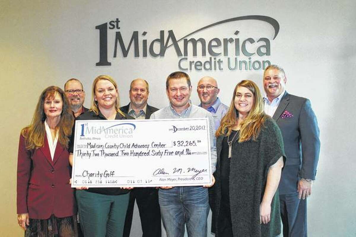 Pictured are, from back left, Perry Withers (1st MidAmerica Credit Union), Bob Blacklock (1st MidAmerica Credit Union), Jason Weiss (Child Advocacy Center) Alan Meyer (1st MidAmerica Credit Union President). Front from left: Patti Bortko (Child Advocacy Center Board Member), Carrie Cohan (Child Advocacy Center Executive Director), Travis Widman (Child Advocacy Center Board Member) and Claire Cooper (Child Advocacy Center).