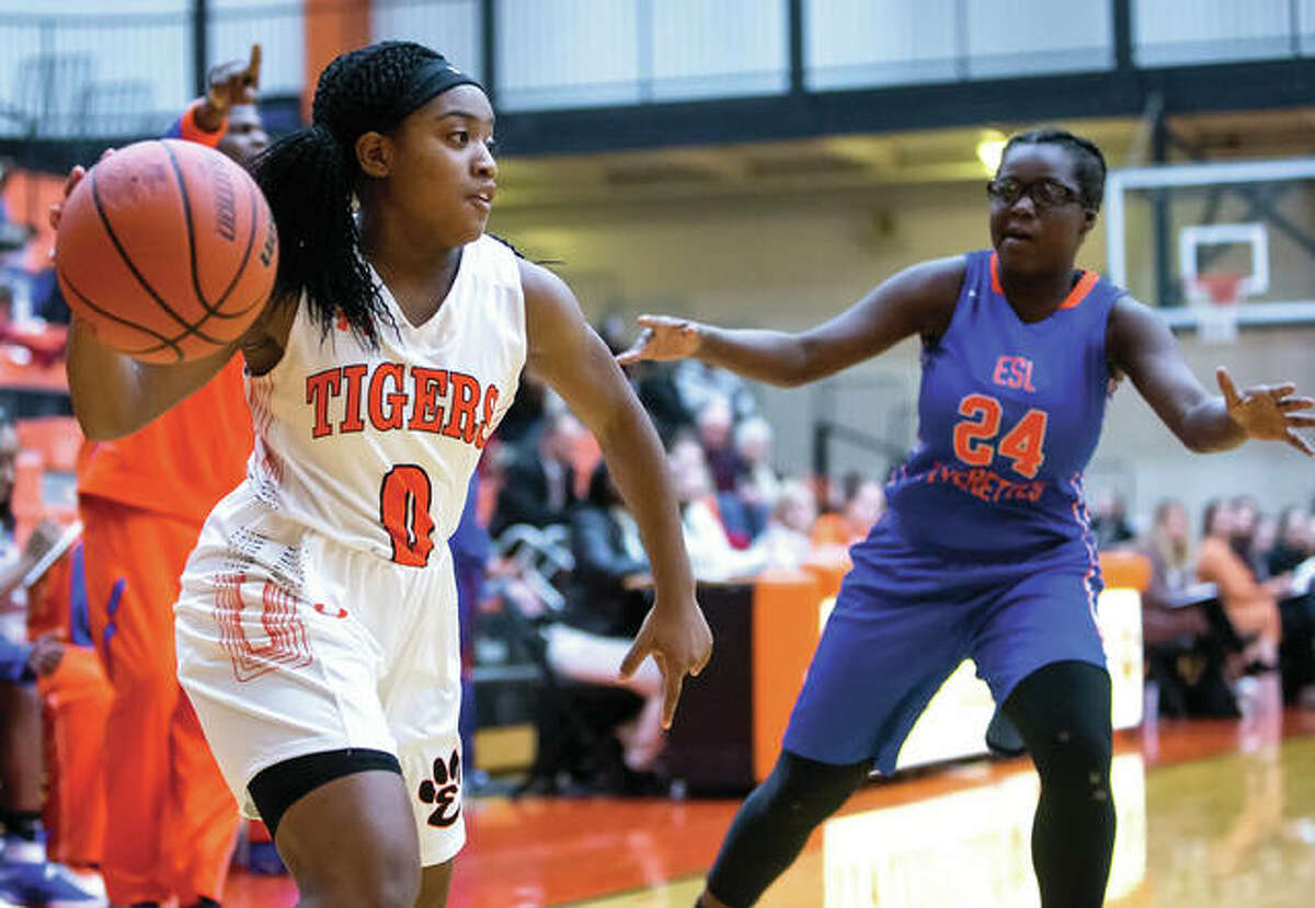 Edwardsville’ point guard Quiera Love (left) makes a pass during SWC play against East St. Louis earlier this season in Edwardsville. Coming off a championship in their first visit to the prestigious Visitation Christmas Tournament, Edwardsville is 16-0 and ranked No. 1 in the state.