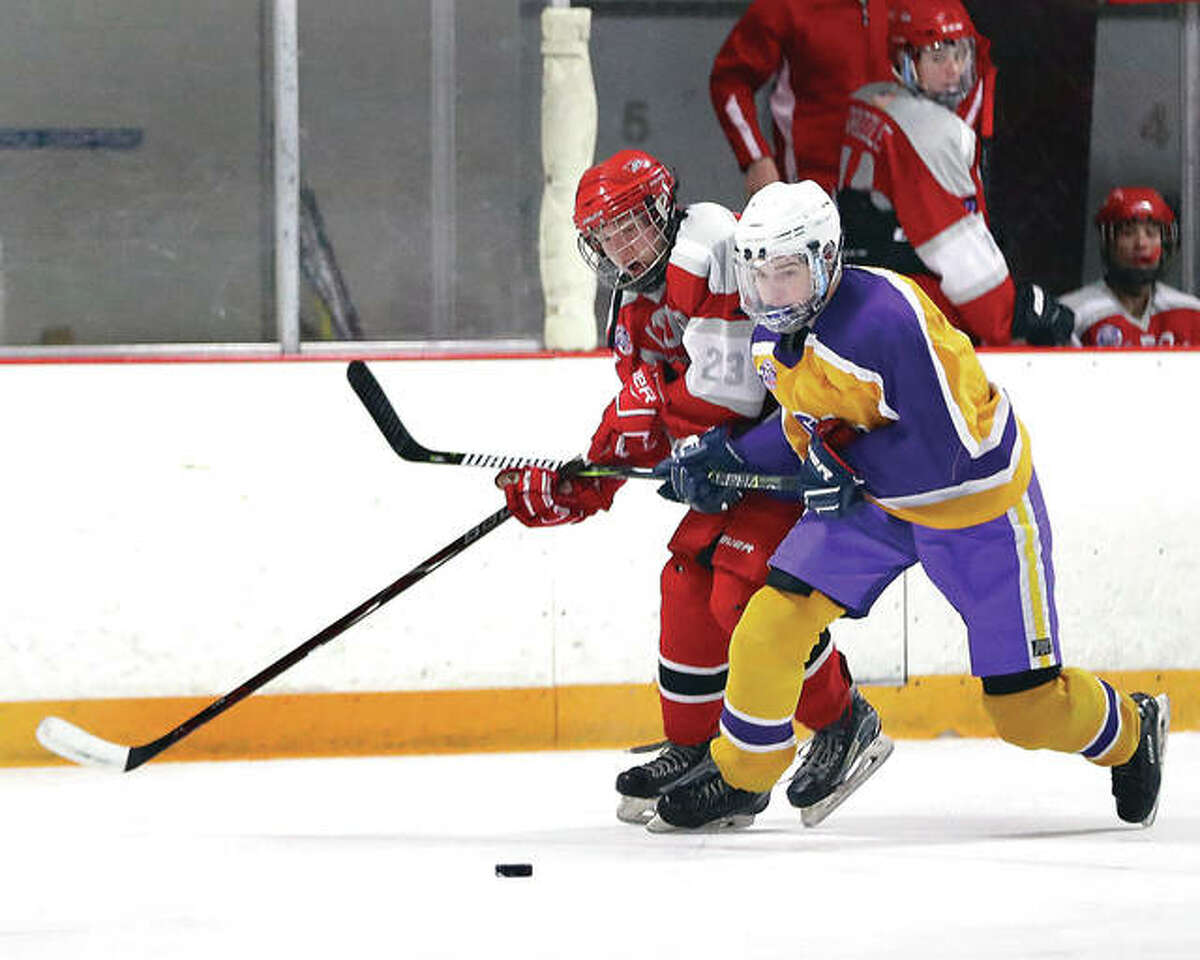 Bethalto’s Nolan Kahl, right, and Alton’s Zach Carter battle for a loose puck during a game earlier this season at East Alton Ice Arena. Bethalto and Alton will compete in Class 1A the rest of the season after the annual late-season re-seeding of the Mississippi Valley Club Hockey Association.