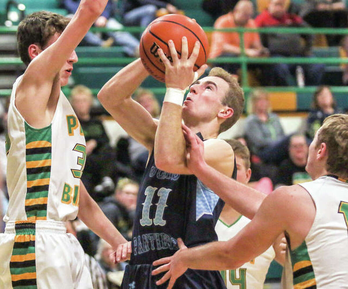 Jersey’s Brett Tuttle drive to the basket against Southwestern’s E.J. Kahl in Tuesday’s 75-45 Panthers victory at Piasa.