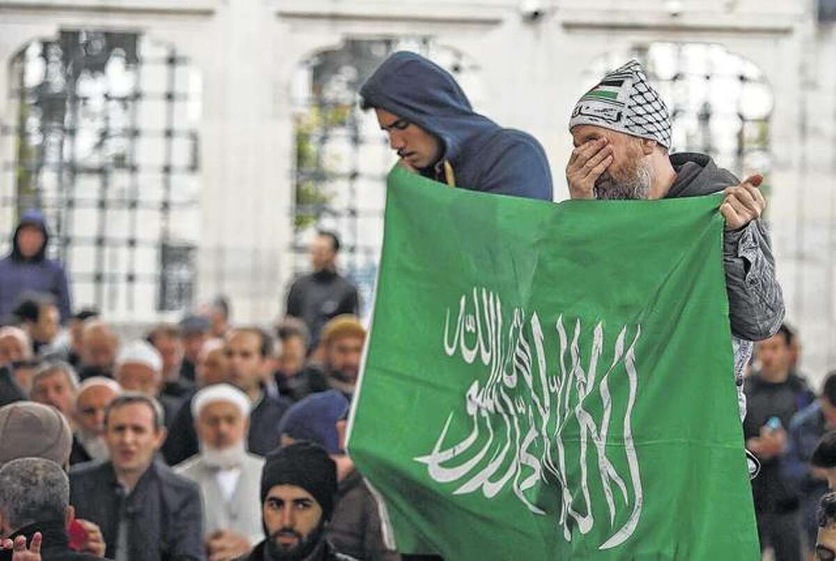 Emrah Gurel | AP People hold an Islamic flag and chant slogans during a demonstration against the suspected chemical attack in Idlib, Syria, following a prayer in Istanbul on Friday. Hundreds gathered in the courtyard of the mosque in Istanbul following Friday prayers to protest against the attack and pray for the victims.