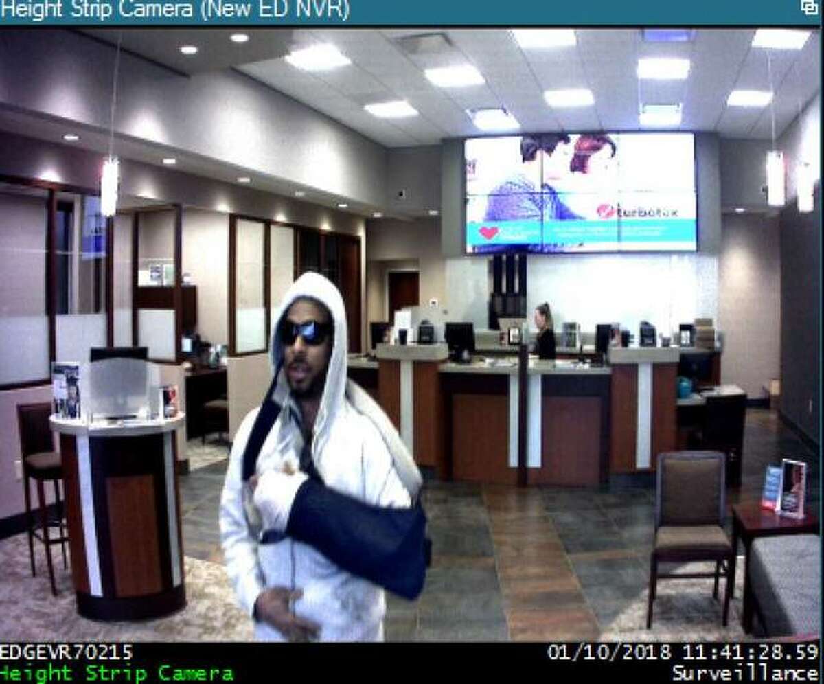 A surveillance image of the suspected bank robber shows his left arm in a sling.