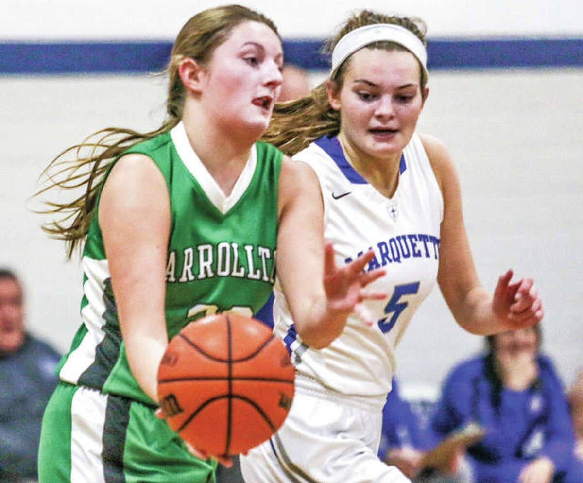 Carrollton’s Kaylie Rhoades (left) pushes the basketball upcourt while under pressure from Marquette Catholic’s Lila Snider during a game Jan. 3 in Alton. Both the Hawks and Explorers were home for games Friday night, with Carrollton losing to Calhoun and Marquette beating Lift For Life.