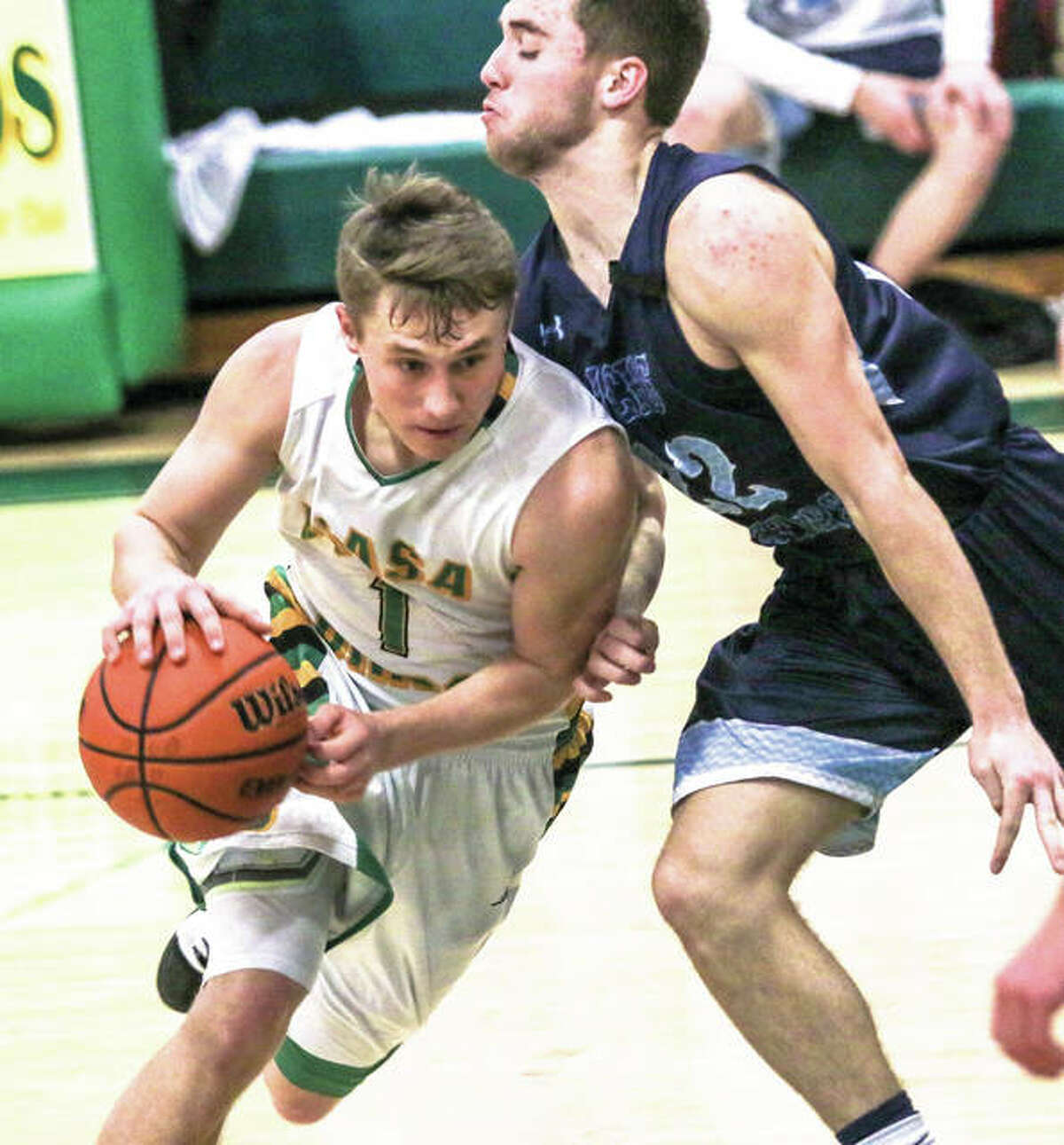 Southwestern’s Justin Bailey (left), shown driving on Jersey’s Nathan Goldacker on Tuesday in Piasa, and the Birds were back at home Friday for a home South Central Conference game with Greenville. The Comets won 48-45.