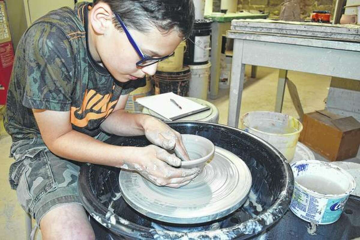Cordin Ledger makes a clay pot Saturday during a class at Strawn Art Gallery.