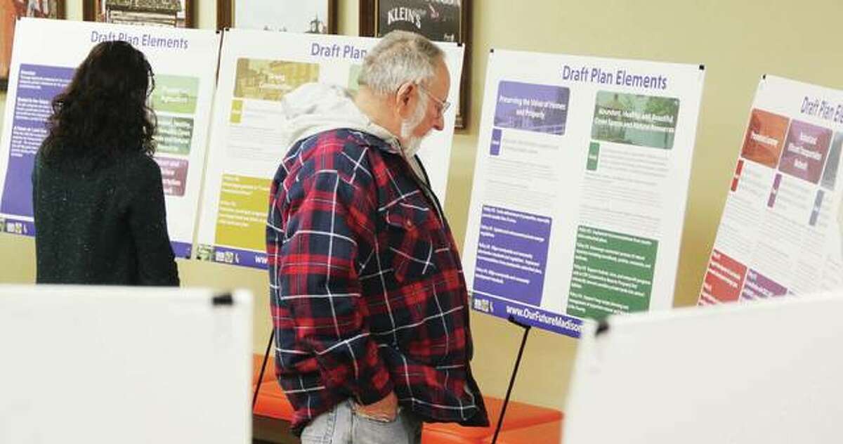 James Donahue, of Cottage Hills, right, and Christine Favilla, representing the Sierra Club, look over displays at an open house for Madison County’s proposed comprehensive plan. Additional open houses were set for today and Wednesday Jan. 17 at the Collinsville City Hall, 125 S. Center St., Collinsville; and Tuesday, Jan. 23 at the Troy Village Hall, 116 E. Market St., Troy. The comprehensive plan serves as the county’s official land use guide, and has not been updated since 2000.