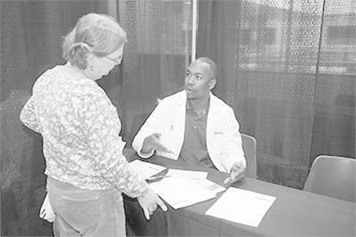 School of Pharmacy student Jamal Sims visits with Cheryl from Highland at SIUE’s 11th annual Free Diabetes Education Program.