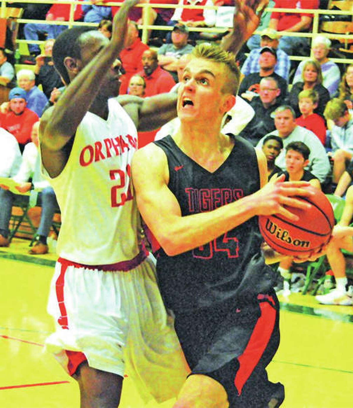 Edwardsville’s Caleb Strohmeier (right) drives to the basket during the fourth quarter of Saturday’s championship game against the Centralia Orphans at the Salem Tournament. Invitational. Strohmeier scored a game-high 24 points, but the Tigers lost the game 76-53.