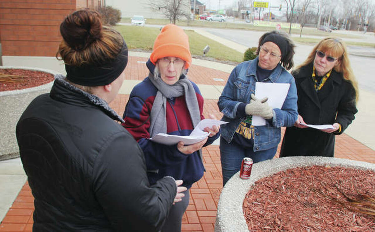 Brittany Pinnon , left, talks to volunteers Diane Martin, JoEllyn Paterson and Martha Rankin after handing out forms for the annual homeless count last year. The group met in front of the Donald E. Sandidge Alton Law Enforcement Center before fanning out. This year’s count is set for Monday.