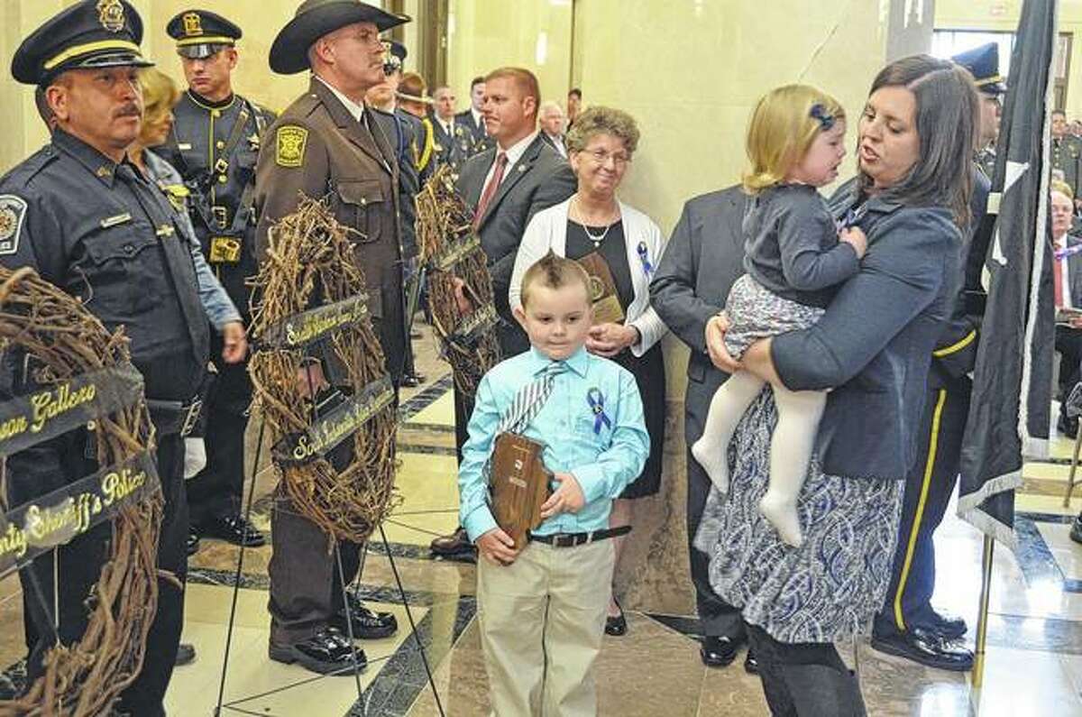 Five-year-old Colton Fitzgerald holds a plaque honoring his father, South Jacksonville Patrolman Francis “Scot” Fitzgerald. The officer died in March 2016 of injuries suffered when his patrol car and an ambulance collided while in route to a medical call.
