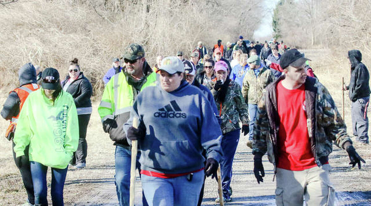 Dozens of volunteers trek to the remote, wooded area where missing Alton woman Adria Hatten’s abandoned vehicle was foundearlier this week.