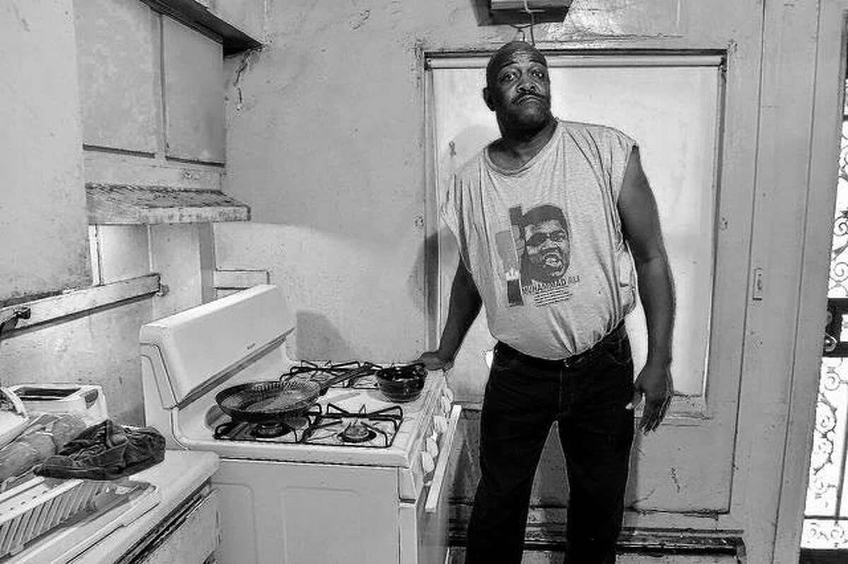 Kenny Simelton talks about issues with his Elmwood apartment in Cairo. Simelton had pulled back the stove to show where rats have been getting in.