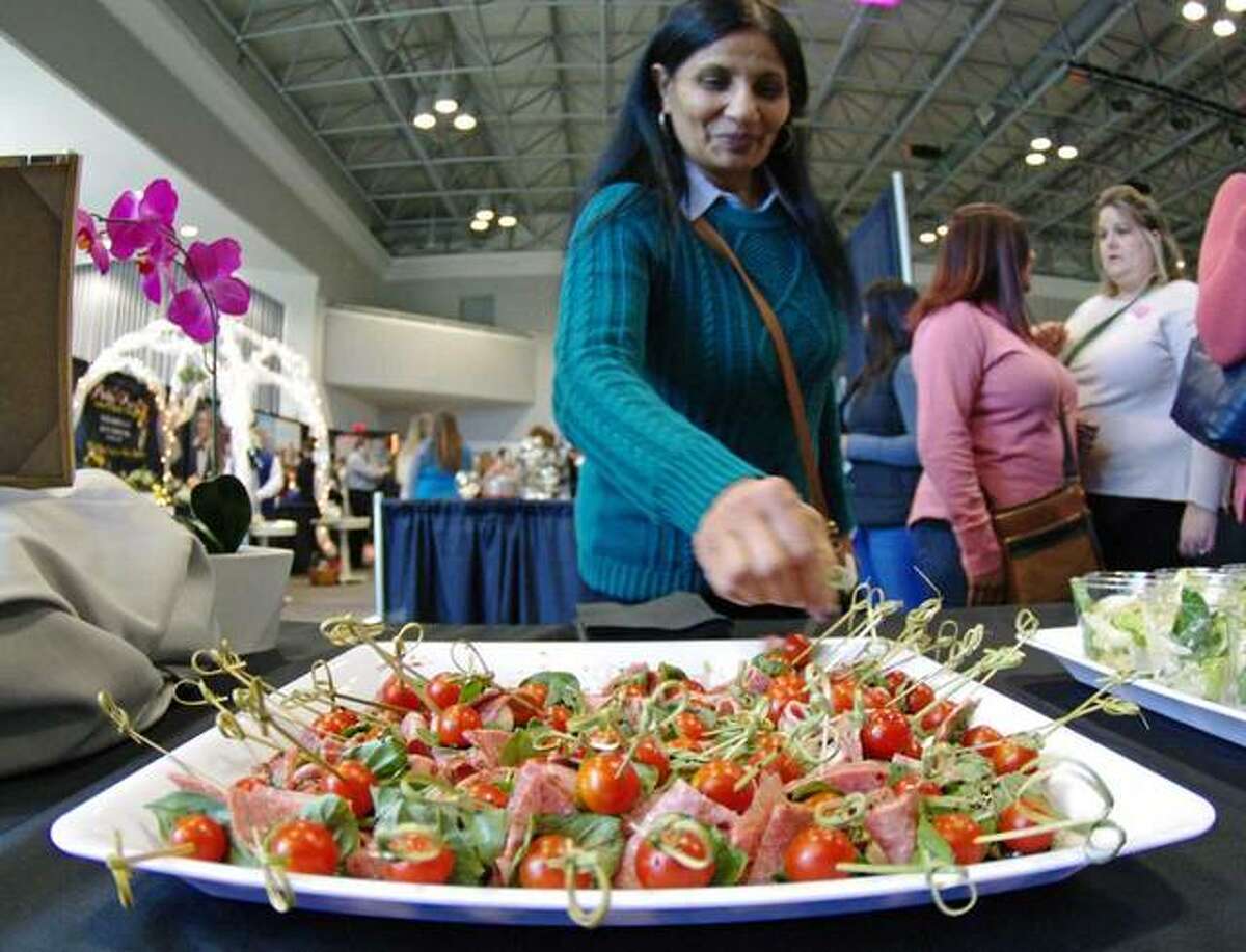 Doris Ramchander, of South Roxana, samples hors d’oeuvres from Bella Milano.