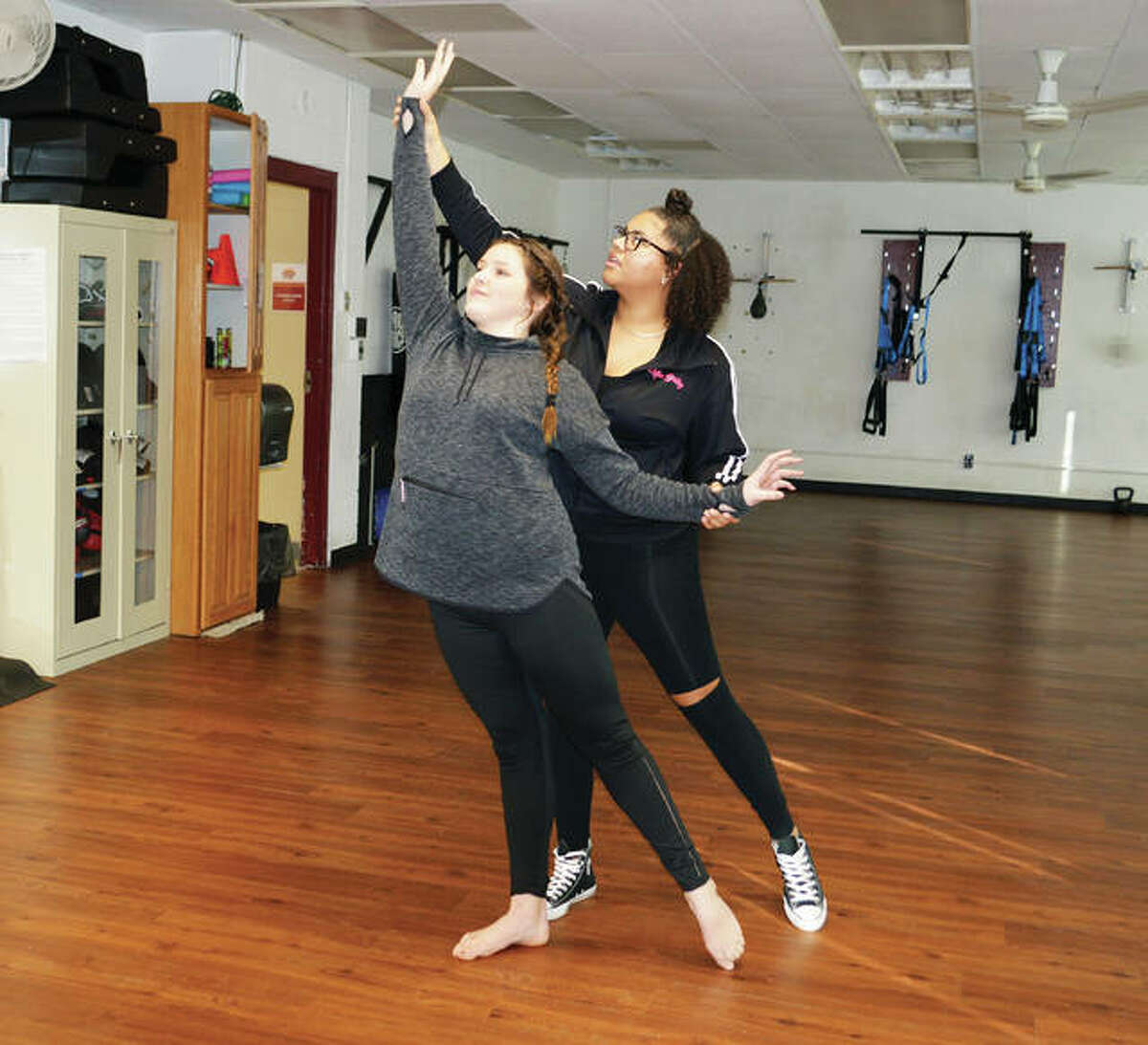 Jennifer Bishop’s School of Dance teacher Bailey McCarry, in back, assists student Sophie Bishop, 14, with a pose to arabesque. Bishop, an avid dancer, also teaches jazz to some of the youngest students enrolled at her mother’s studio, located at Senior Services Plus in Alton.
