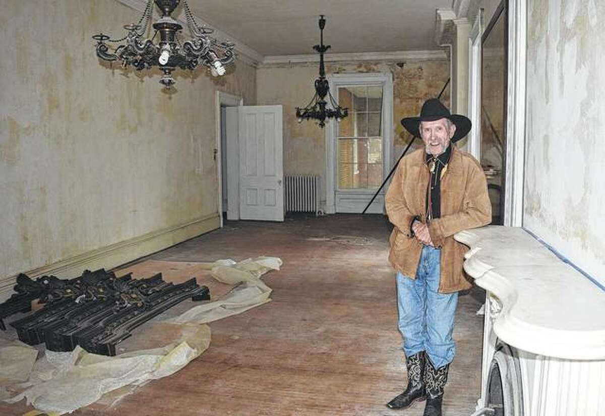 The new owner of the Ayers house, E. Scott DeWolf, stands in the first-floor ballroom.