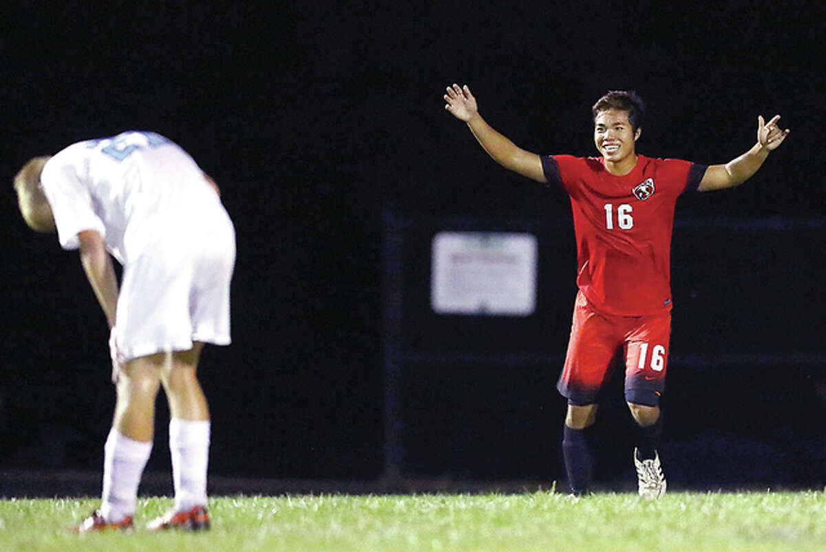 Alton’s Steven Nguyen, right, celebrates after scoring a goal as Jersey’s Drake Blackwell reacts in dejection during Monday’s match played in Jerseyville.