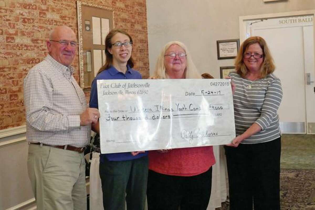 Pilot Club President Patty Osborne (second from right) and Treasurer Bridget Rahe (right) present a check to Western Illinois Youth Camp officials Bob Large (left) and Kori Daniels. Pilot Club’s $4,000 donation will help with infrastructure improvements at the camp.