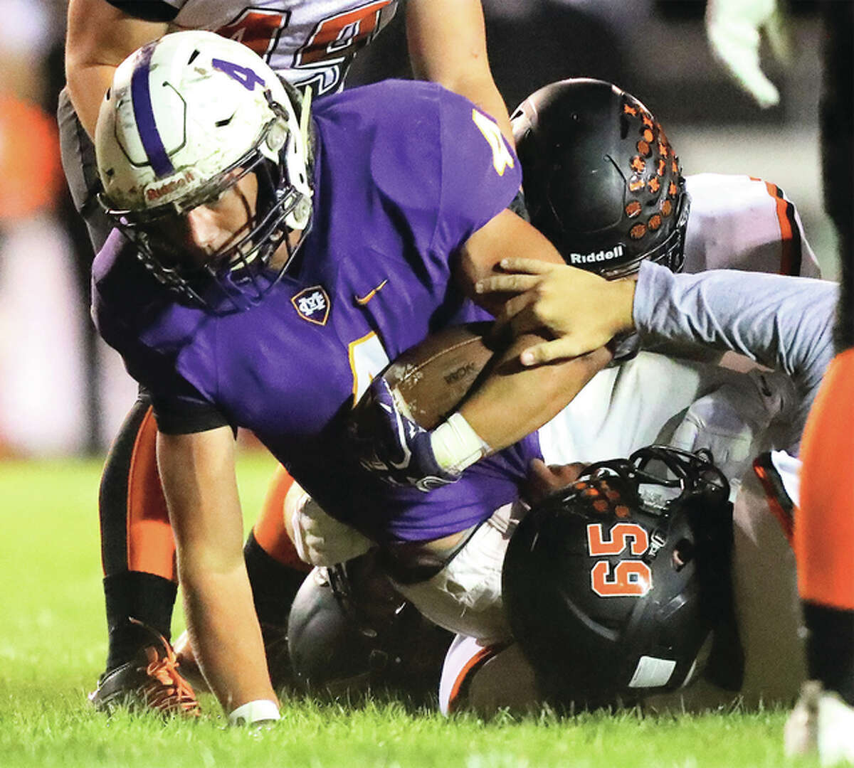 Civic Memorial’s Nick Newell fights for extra yards as he is tackled by a host of Waterloo defenders during Friday night’s Mississippi Valley Conference game in Bethalto. CM won 20-15 to improve to 5-2.