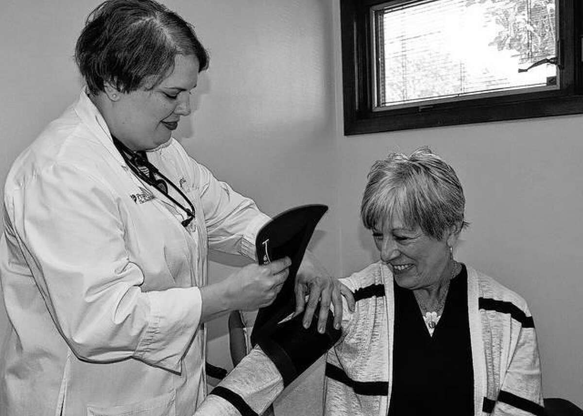 Angela LaFrenz checks Theresa Thompson’s blood pressure Tuesday during the opening of Prairie Cardiovascular’s multi-specialty clinic in Jacksonville. The clinic is at 1515 W. Walnut St., Building 9.
