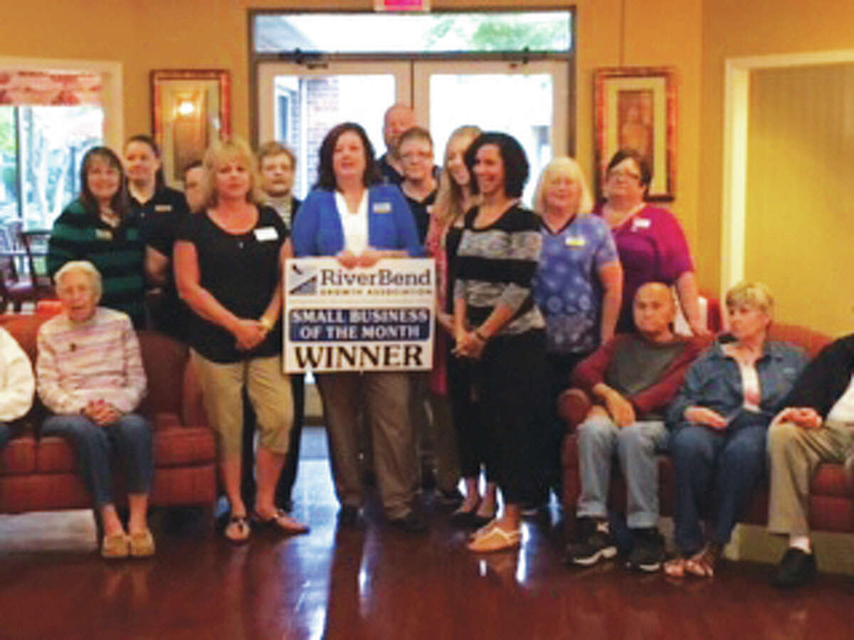 Foxes Grove and RiverBend Growth Association staff pose for a picture at the supportive living community. Foxes Grove was named the association’s Small Business of the Month for October.