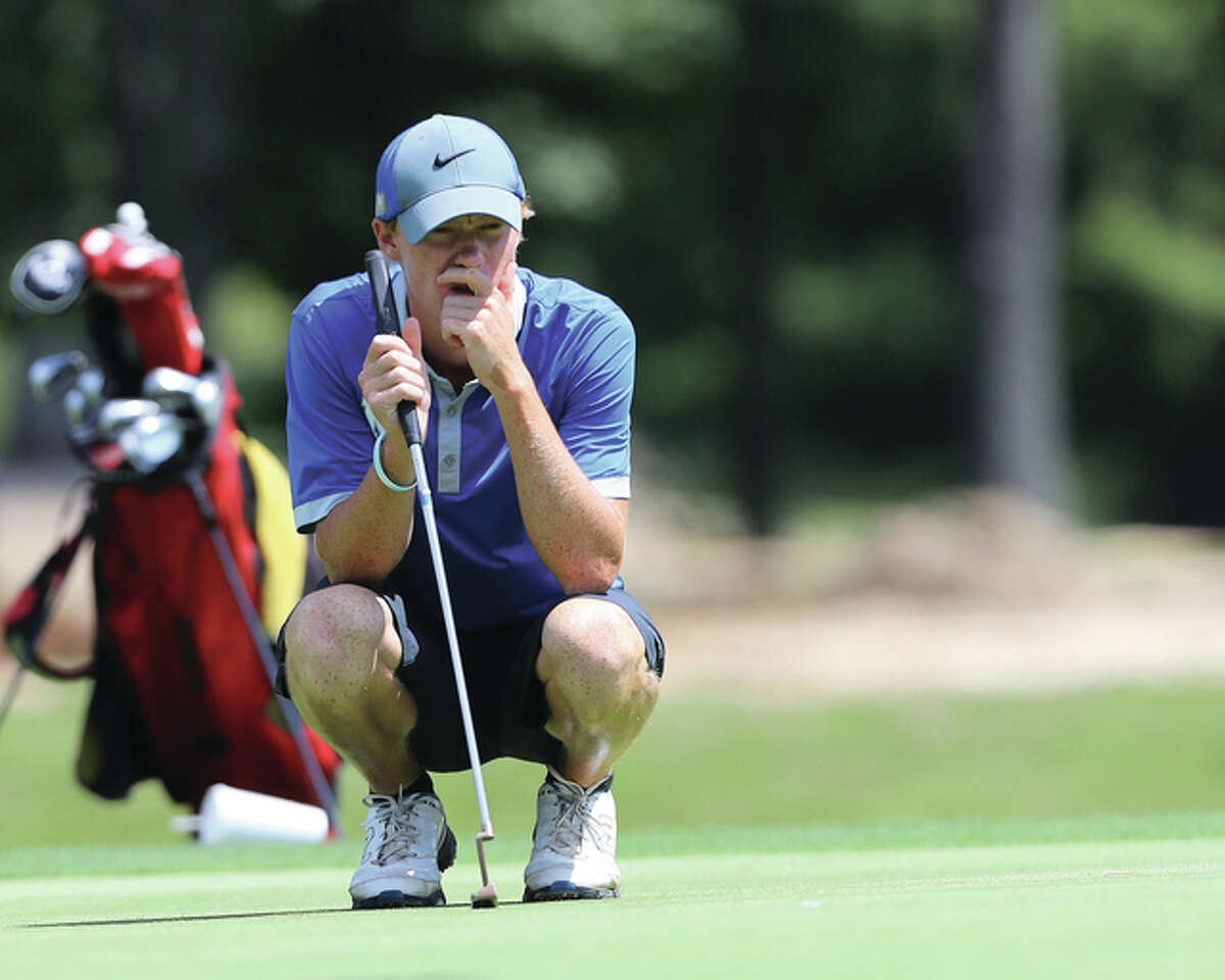 Marquette Catholic senior Michael Holtz, shown lining up a putt during the Madison County Tournament at Belk Park on Aug. 18, shot 72 at the Mattoon Class 2A Sectional on Tuesday to win medalist honors at Mattoon Country Club.