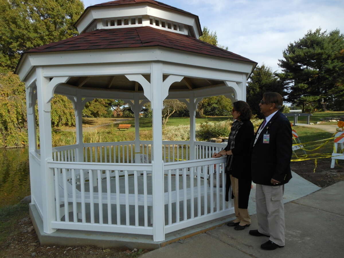 Dr. Sadiq and Talat Mohyuddin, founders of the Oriental Garden, admire the newly completed gazebo that Jun Construction workers assembled this week at the garden, in Gordon F. Moore Community Park. The $7,717 structure replaced a circa 1985 wooden gazebo the city demolished, the new one paid for with donations. The city paid for the assembly and concrete pad and walkway.